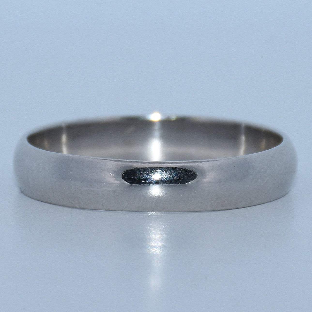 Silver ring on a light gray background
