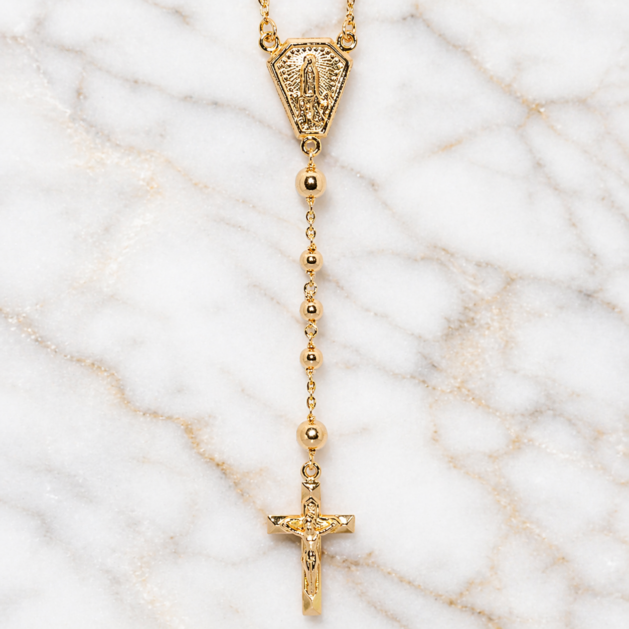 Gold rosary necklace on a marble surface 19.2K Portuguese Gold | Rosary Necklaces 18 inch