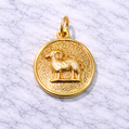 19.2K Portuguese Gold zodiac pendant with Aries goat symbol on a marble surface