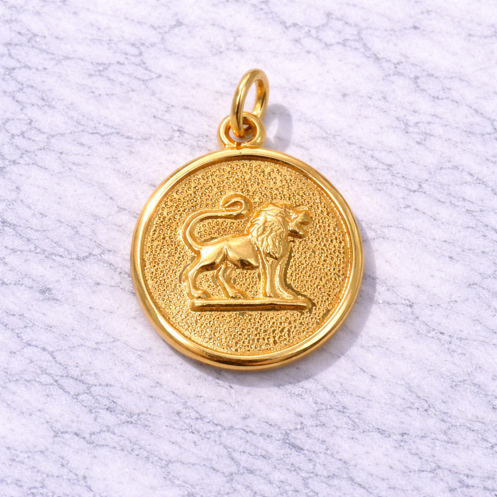 19.2K Portuguese Gold Leo lion pendant on a marble surface