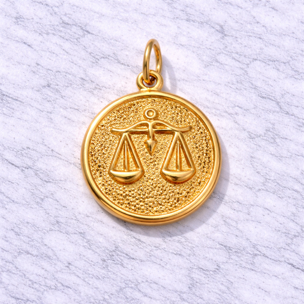 19.2K Portuguese Gold Libra zodiac pendant on a light gray background