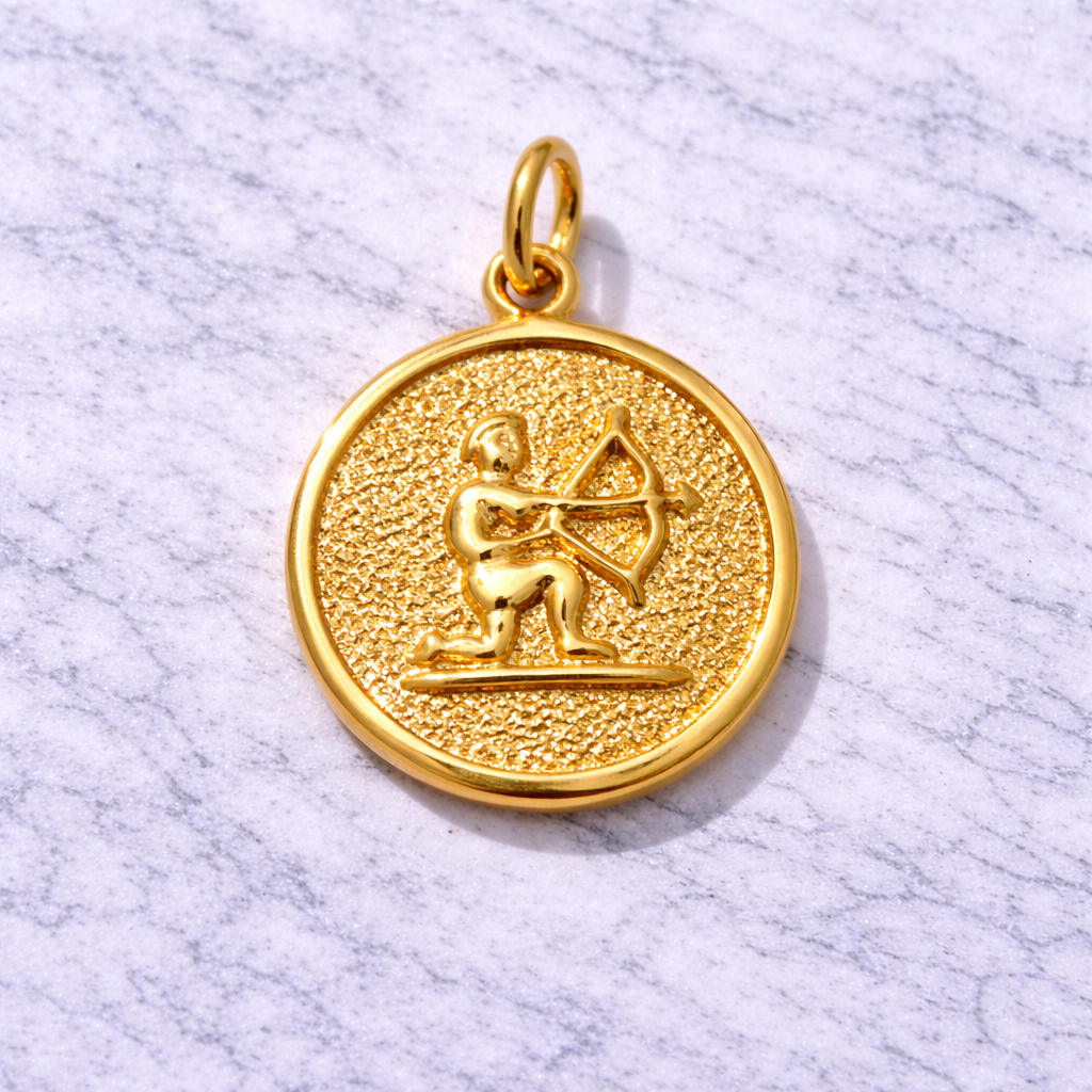 19.2K Portuguese Gold Sagittarius zodiac pendant with archer design on a marble surface