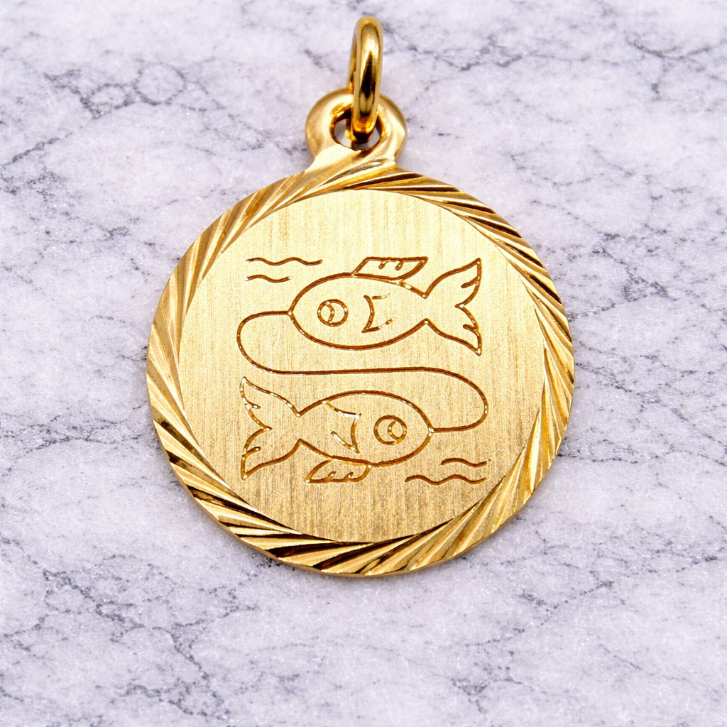 19.2K Portuguese Gold Pisces zodiac pendant on a marble surface