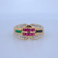 Gold ring with colored gemstones on a light blue background