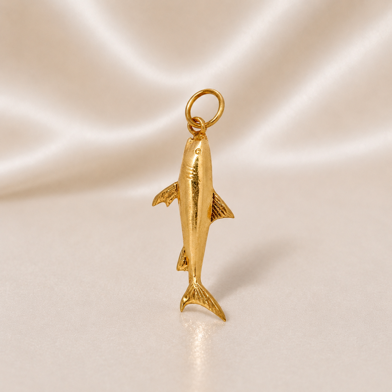 Gold dolphin pendant on a satin background 19.2K Portuguese Gold | Shark Charm 