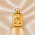 Gold pendant with Libra zodiac symbol on a beige satin background 19.2K Portuguese Gold | Square Zodiac Charms