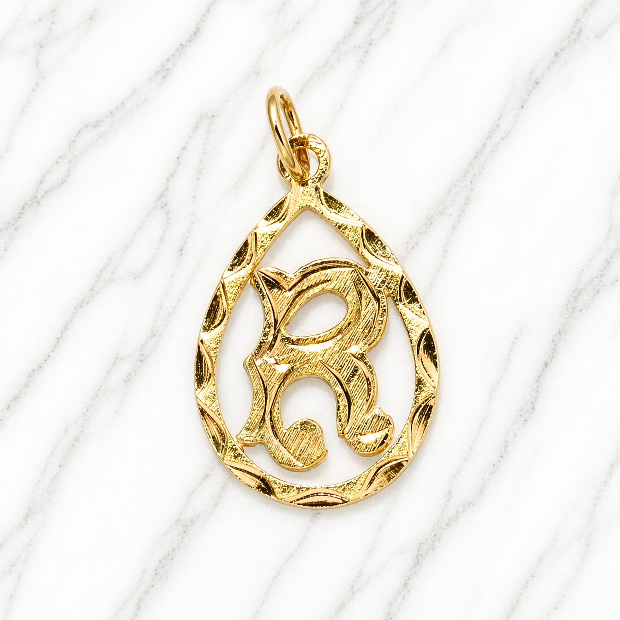 Gold pendant with a decorative design on a white background 19.2K Portuguese Gold | Tear Drop Letters Letter R 