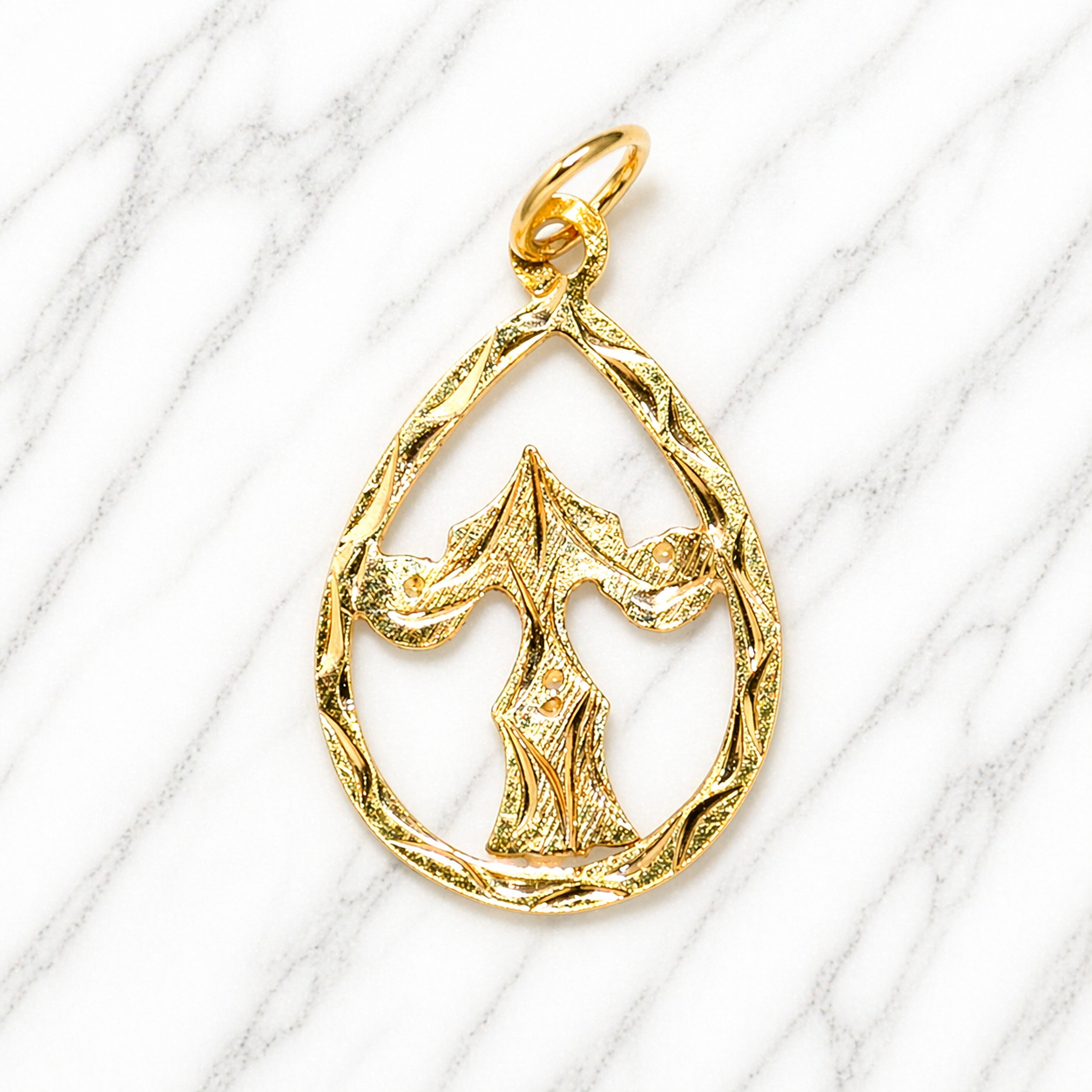 Gold pendant on a white marble  background 19.2K Portuguese Gold | Tear Drop Letters Letter T 