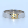 Silver ring with a gold '25' cutout on a light blue background