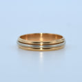 Gold and silver ring on a light blue background