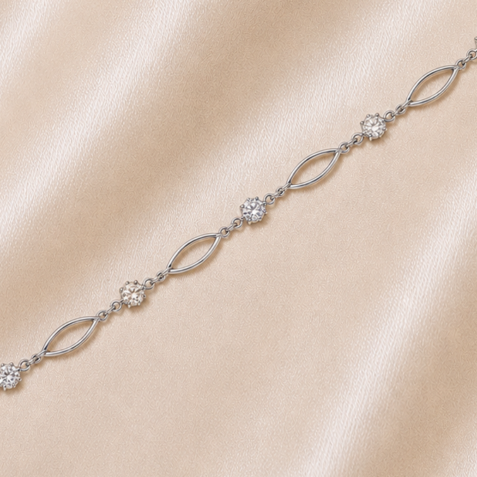 Silver bracelet with clear stones on a beige fabric background19.2K Portuguese Gold | WG Oval Link & CZ Bracelet