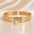 Gold bracelet with heart charm on a beige satin background 19.2K Portuguese Gold | 7 Band Bracelet Bangle with Dangle Heart