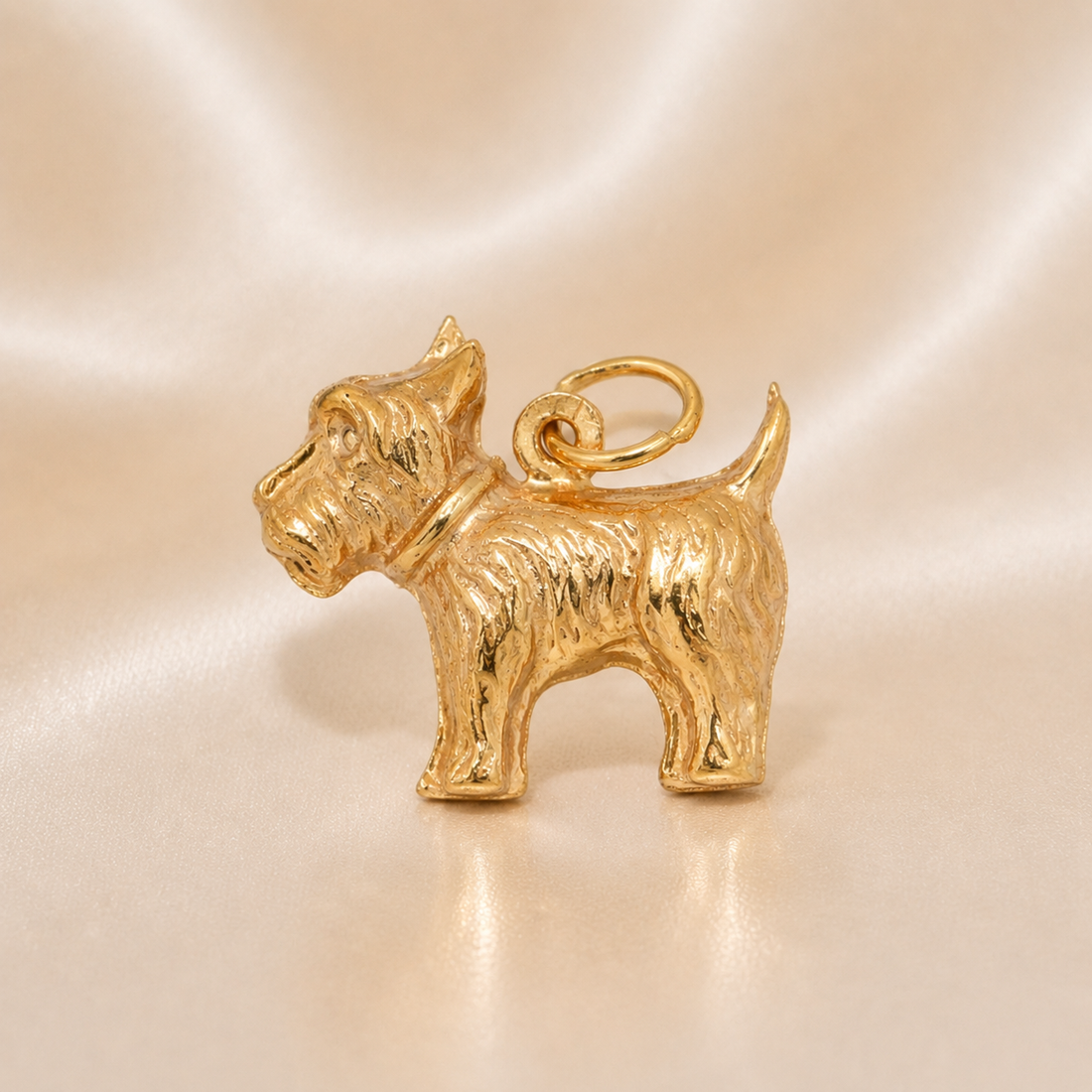 Gold dog-shaped charm on a beige background 19.2K Portuguese Gold | Scottish Terrier Dog Charm 