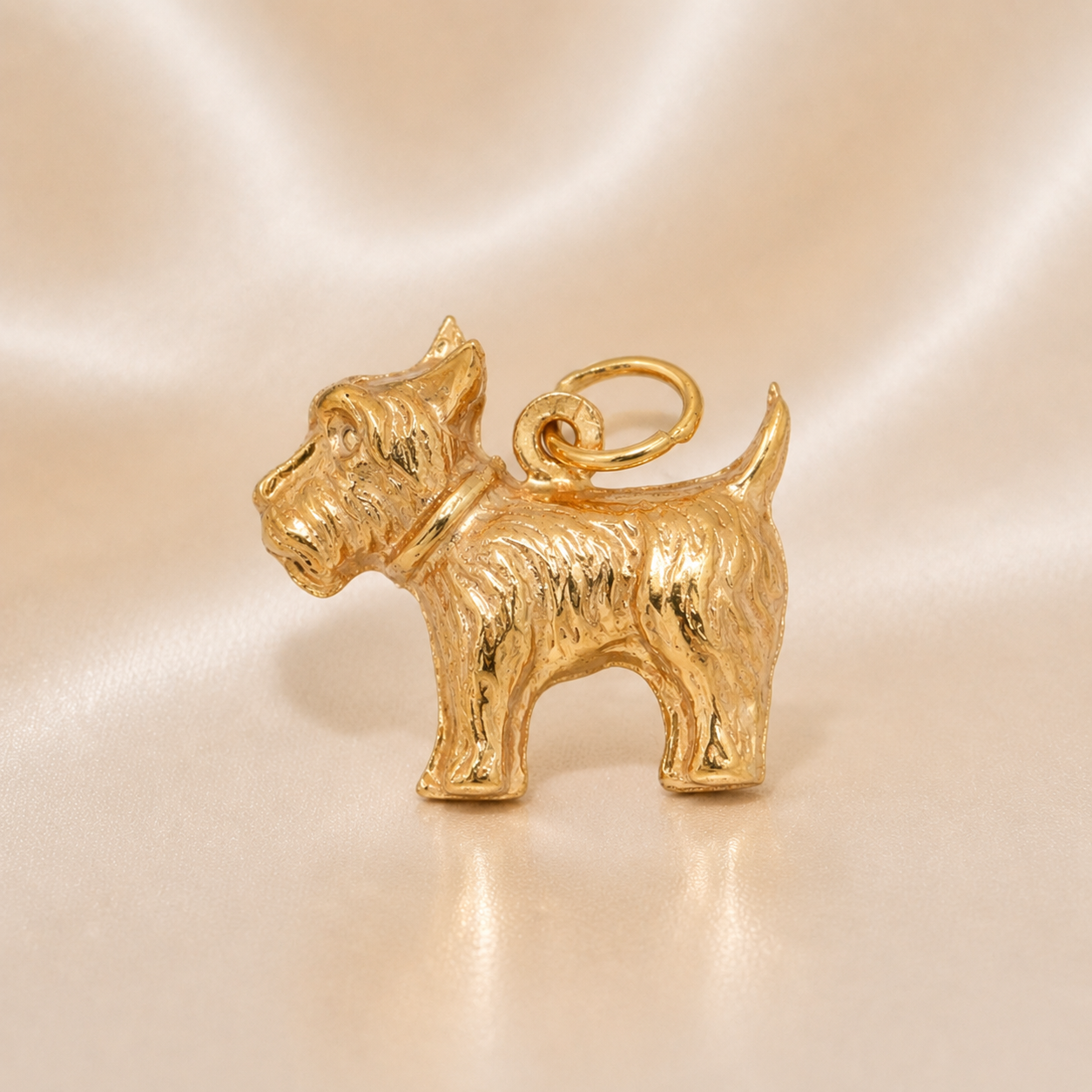 Gold dog-shaped charm on a beige background 19.2K Portuguese Gold | Scottish Terrier Dog Charm 