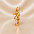 Gold seahorse pendant on a beige satin background 19.2K Portuguese Gold | Seahorse Charm
