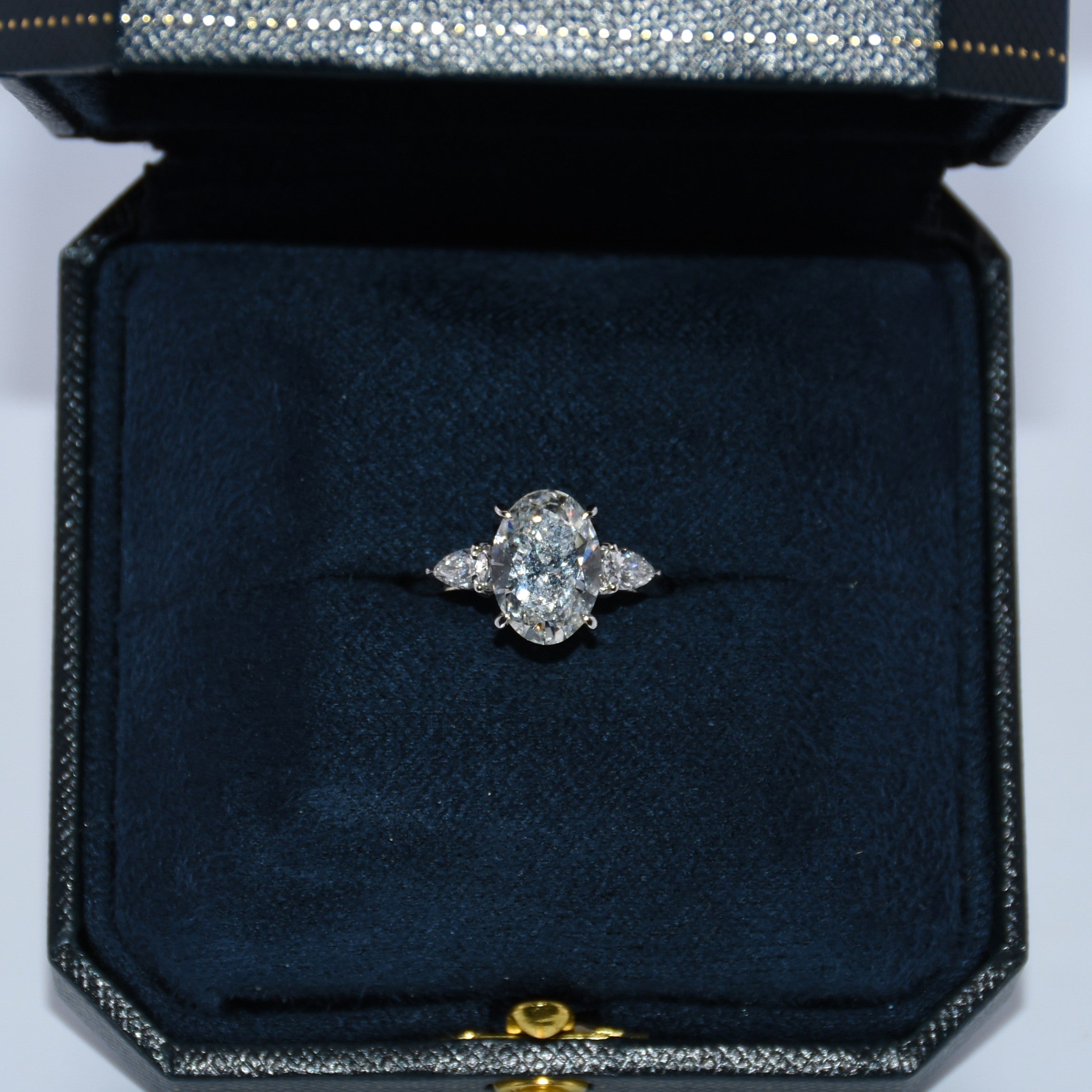 Diamond ring in a black jewelry box on a white background
