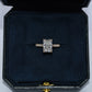 Diamond ring in a dark blue jewelry box on a light gray background
