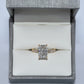 Diamond ring in a gray jewelry box on a light gray background