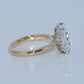 Gold ring with a diamond on a light gray background