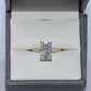 Diamond ring in a gray jewelry box on a white background