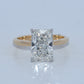 Gold ring with a large diamond on a light gray background