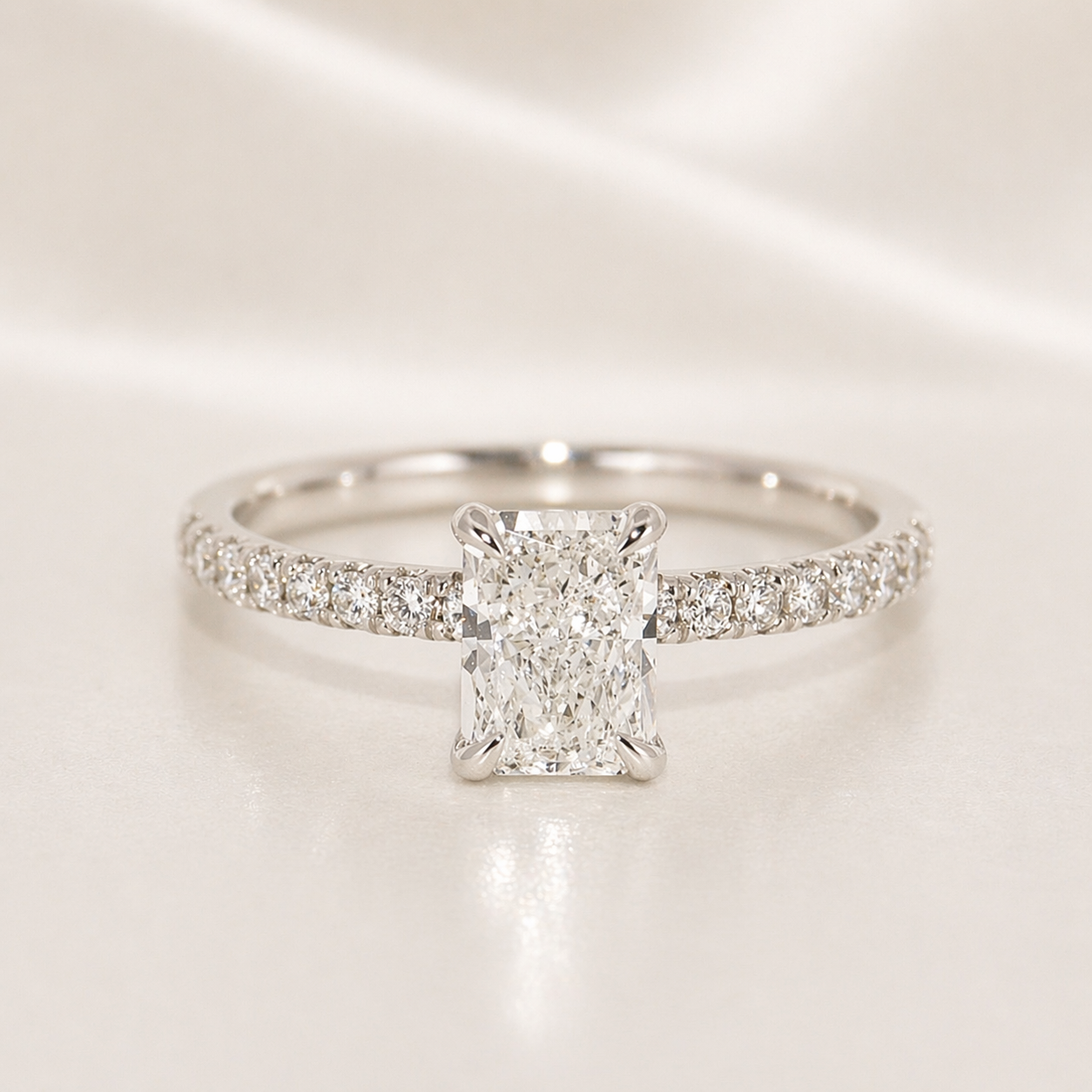 Diamond ring with a central gemstone and smaller diamonds on a light background