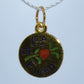 Gold pendant with 'LCA DE FILHO' text and heart design on a light blue background