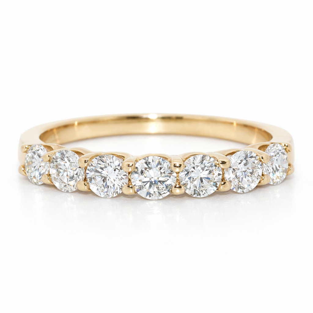 Gold ring with round diamonds on a white background