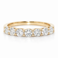 Gold ring with round diamonds on a white background