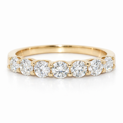 Gold ring with round diamonds on a white background