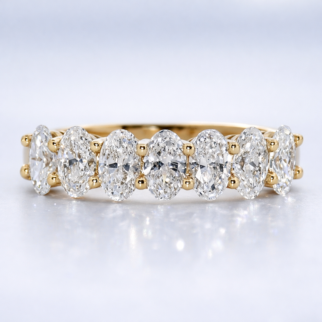 Gold and diamond ring on a light gray background
