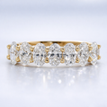 Gold and diamond ring on a light gray background