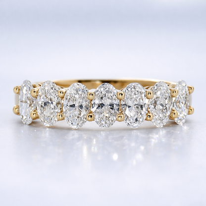 Gold and diamond ring on a light gray background