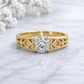 Gold ring with diamond on a marble surface