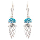 A pair of silver leverback dangle earrings featuring a glittery blue jellyfish design with silver tentacles, shown against a plain white background.