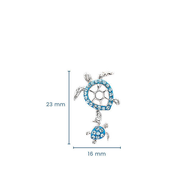 Silver-toned turtle pendant charm with blue rhinestone accents, shown with dimension lines indicating a height of 23 mm and width of 16 mm on a white background.