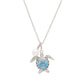 A silver-toned sea turtle pendant necklace with a light blue patterned shell, a white pearl bead, and small clear rhinestone accents on a white background.