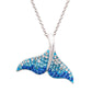A silver-tone mermaid tail pendant necklace adorned with blue and clear rhinestones, suspended from a silver chain on a white background.