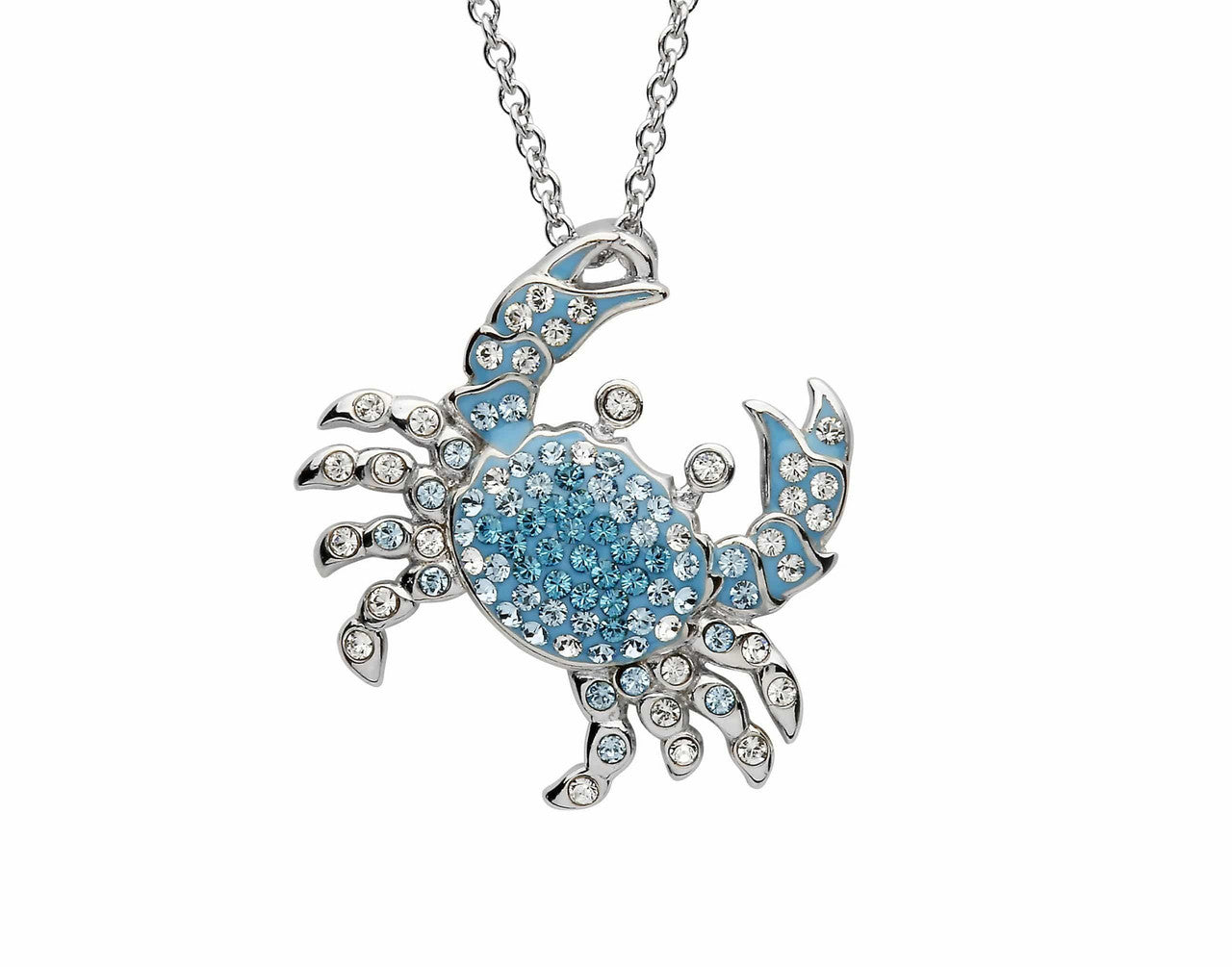A silver-toned crab pendant necklace adorned with light blue rhinestones and clear crystals, hanging from a silver chain against a plain white background.