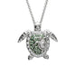 A silver sea turtle pendant necklace adorned with clear crystals and green enamel details, suspended from a silver chain against a plain white background. Ocean | Sterling Silver Green Swarovski Crystal Turtle and Baby Necklace