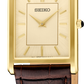 Seiko watch with gold case and brown leather strap on a white background