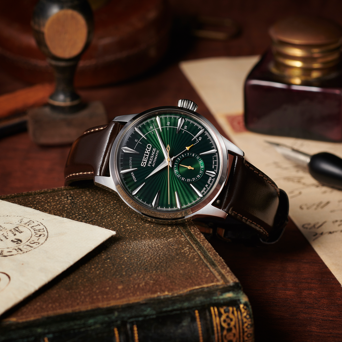 Green Seiko watch on an old book with a vintage setting