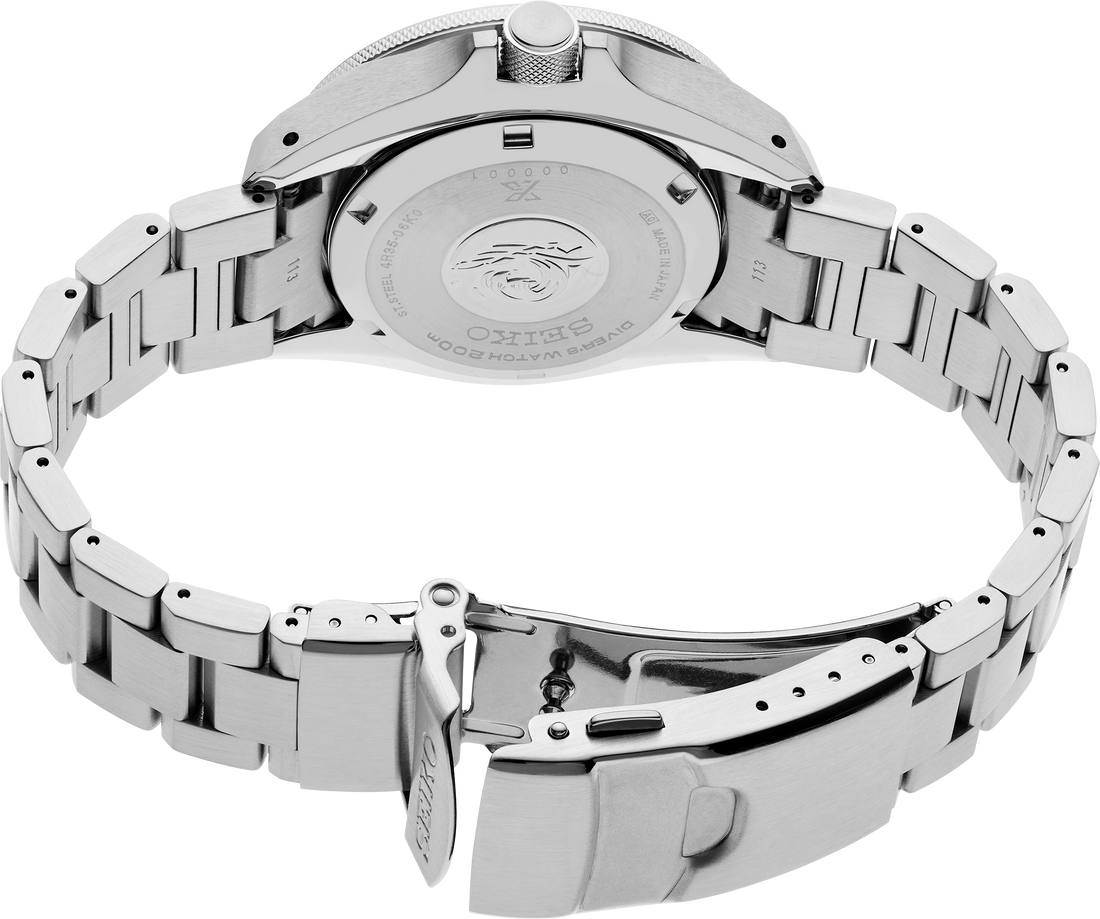 Close-up of a silver watch with a metal band on a white background