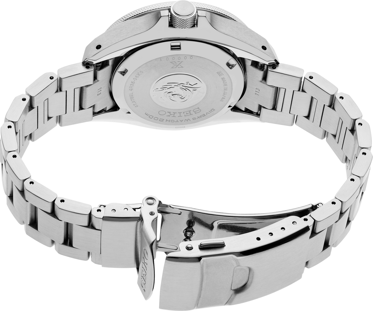 Close-up of a silver watch with a metal band on a white background