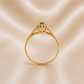 Simple solitaire band with a cluster of CZ's and a green stone