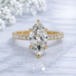 Gold ring with a large pear-shaped diamond on a light background