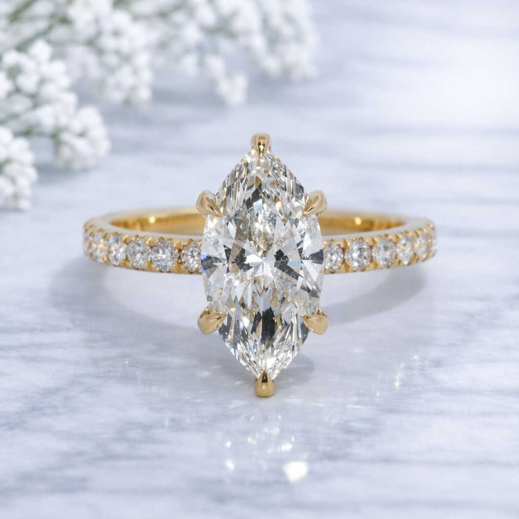 Gold ring with a large pear-shaped diamond on a light background