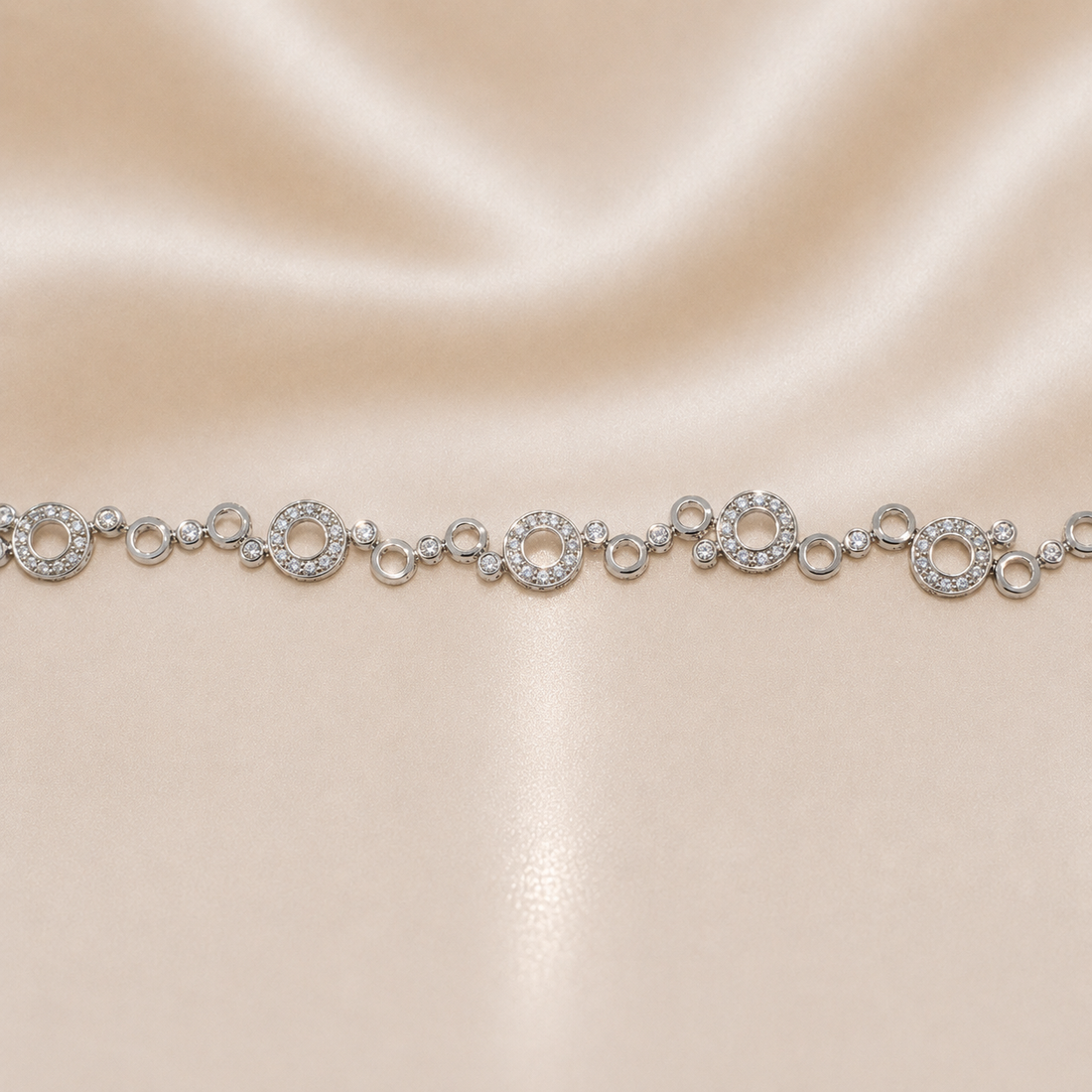 Silver bracelet with circular links on a beige satin background Sterling Silver | 8" Circular Halo Link Bracelet