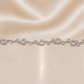 Silver bracelet with circular links on a beige satin background Sterling Silver | 8" Circular Halo Link Bracelet