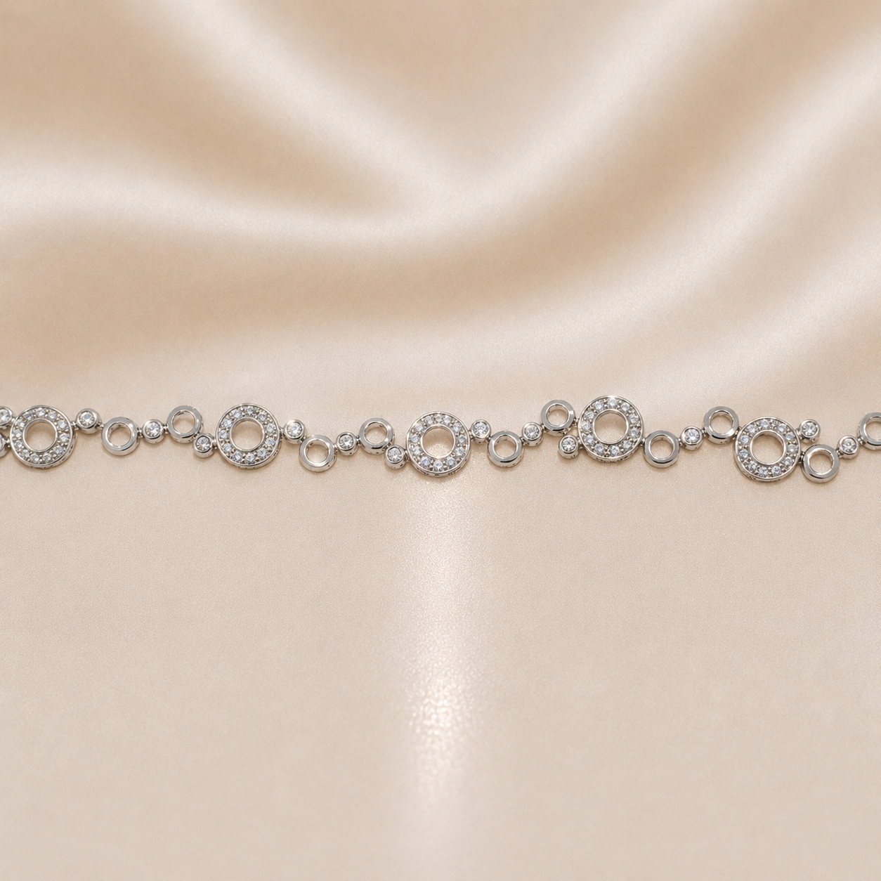Silver bracelet with circular links on a beige satin background Sterling Silver | 8" Circular Halo Link Bracelet